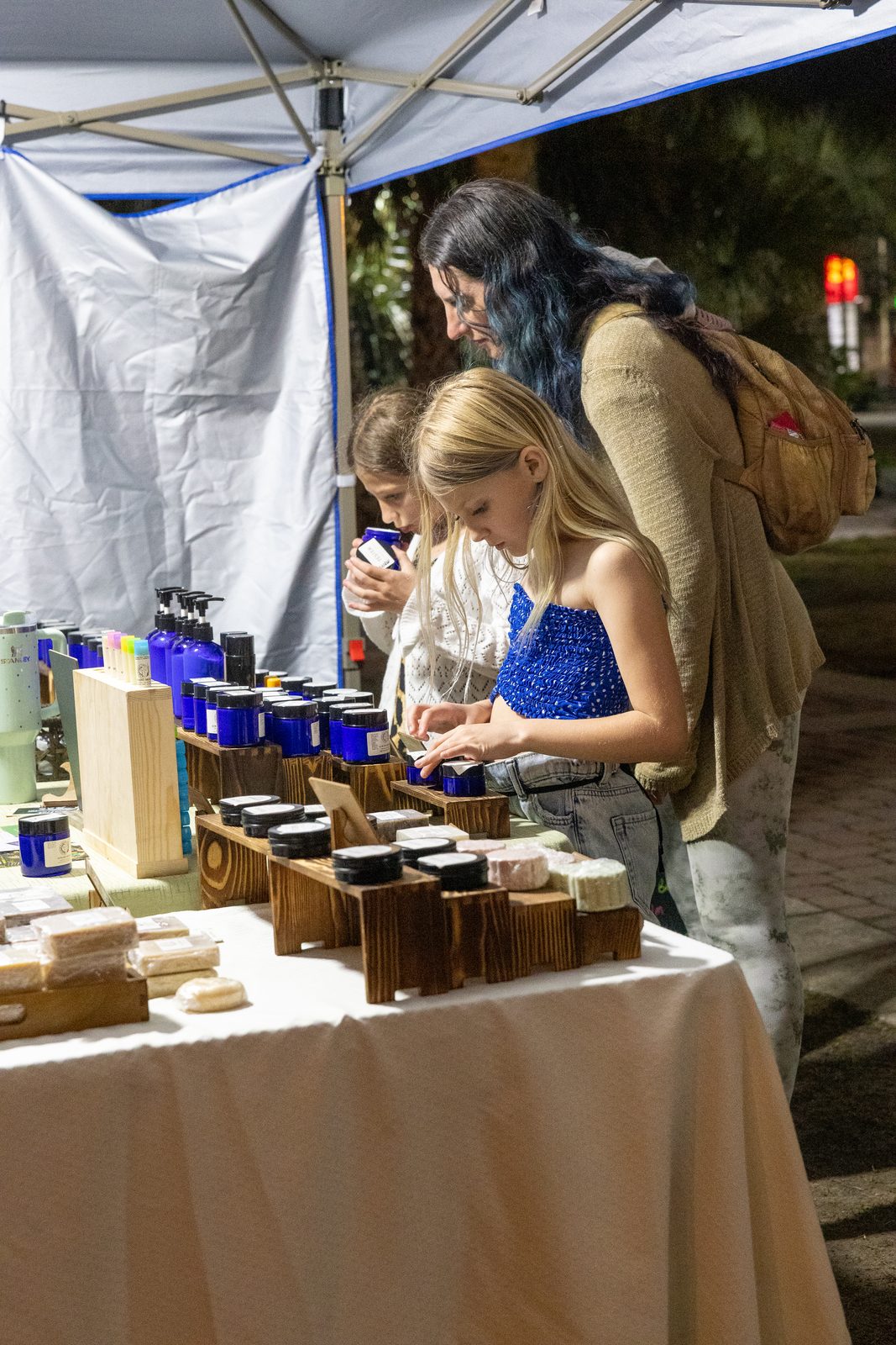 Family browsing at a handmade soap stall